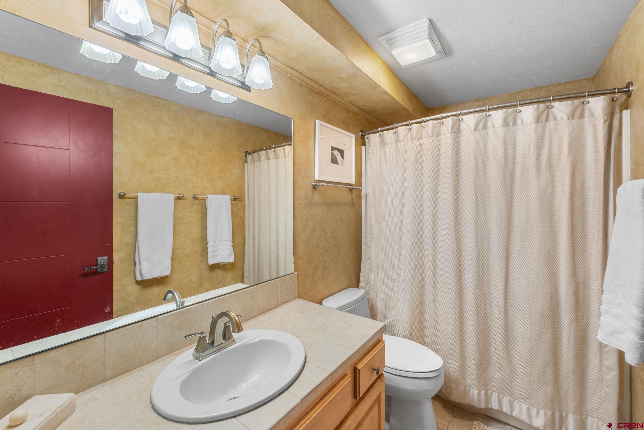 651 Gothic Road, Unit 505 Crested Butte, CO 81225 - Photo 10 of 44 a bathroom with a granite countertop sink a toilet and a mirror