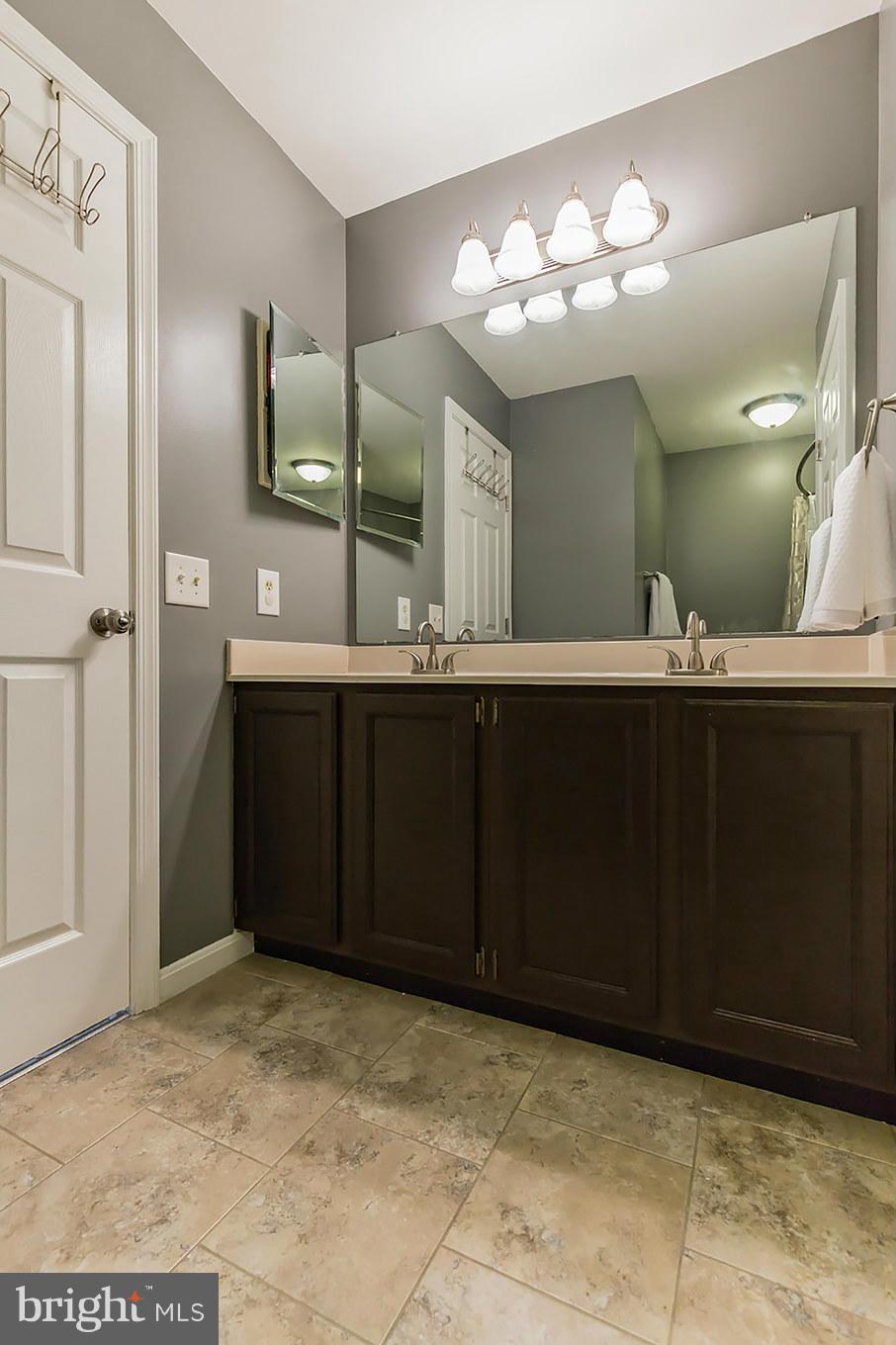 4436 Cole Farm Road Baltimore, MD 21236 - Photo 19 of 30 a bathroom with a sink and a mirror