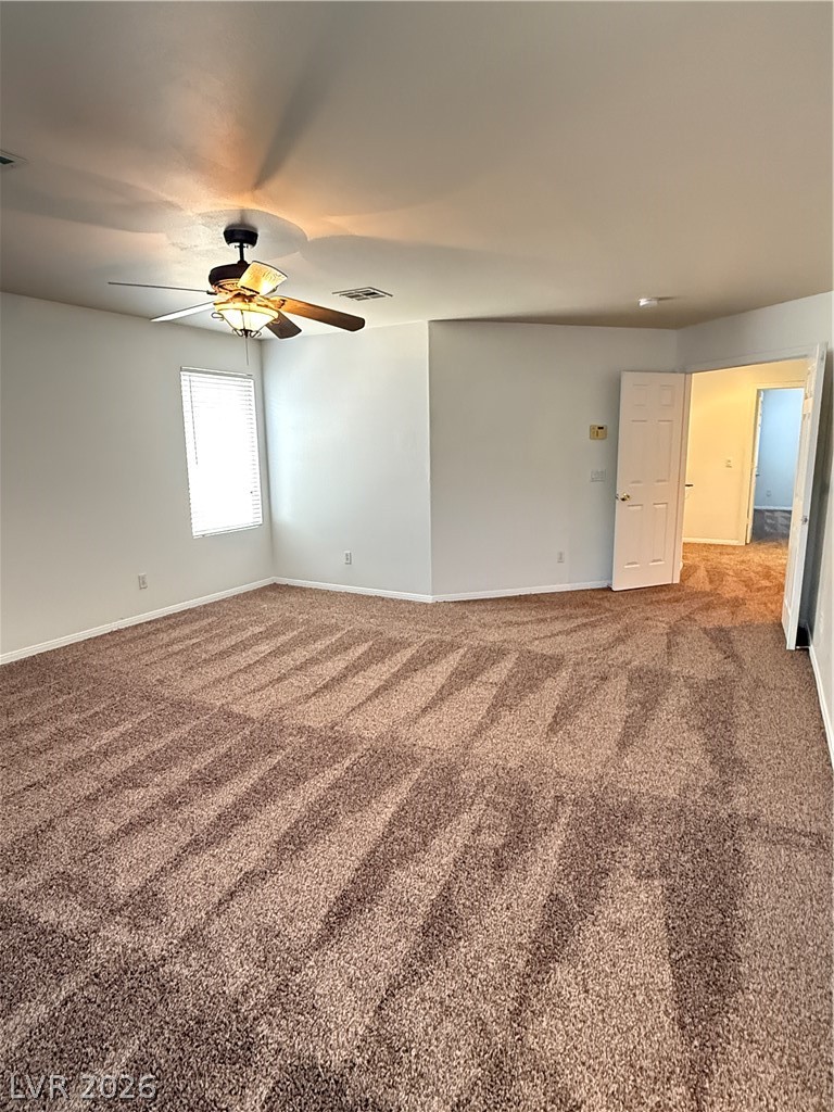 10975 Calcedonian Street Las Vegas, NV 89141 - Photo 23 of 25 This cozy bedroom features plush carpet and a ceiling fan, perfect for comfortable living.
