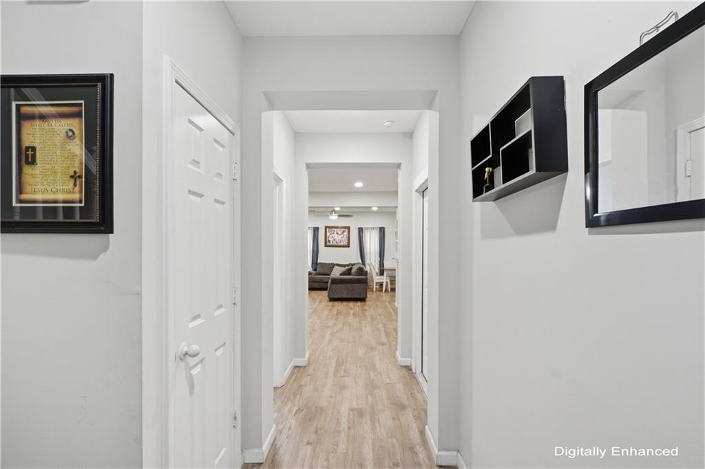 2555 Flat Shoals Road, Unit 2008 Atlanta, GA 30349 - Photo 4 of 33 a view of a hallway with wooden floor and a living room