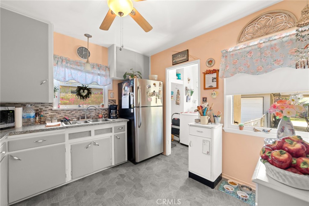 3924 Wayne Court Riverside, CA 92504 - Photo 16 of 31 a kitchen with white cabinets and white appliances