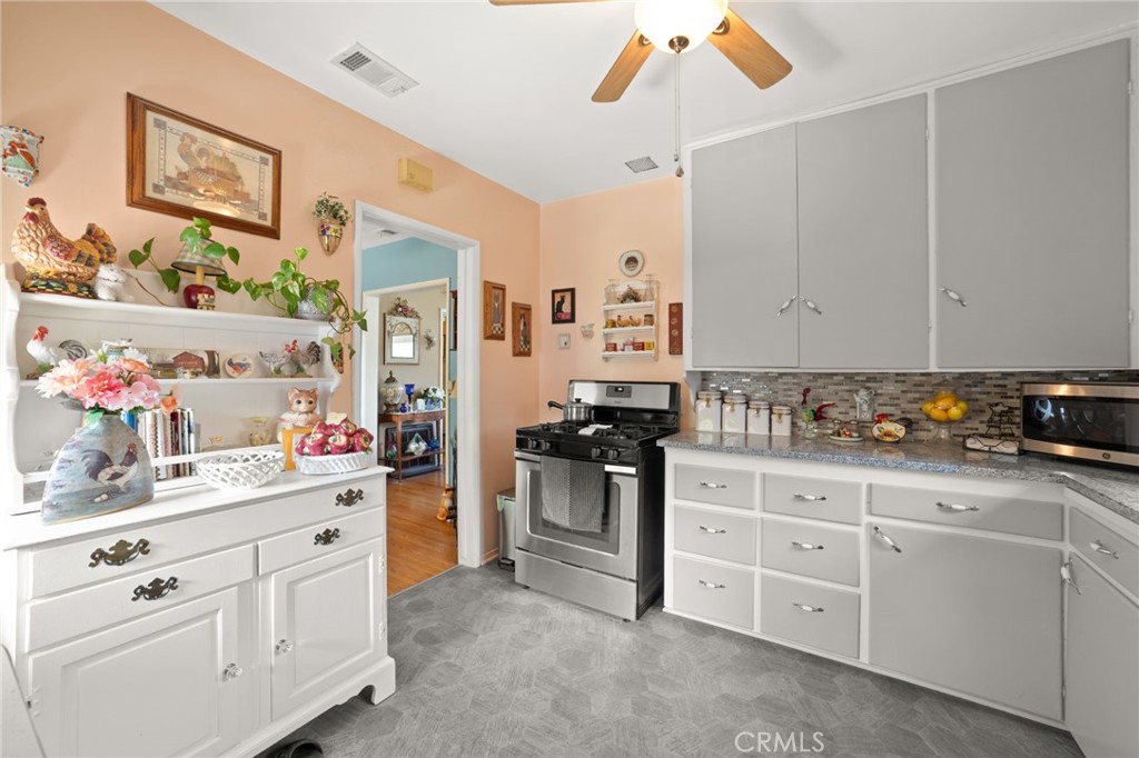 3924 Wayne Court Riverside, CA 92504 - Photo 17 of 31 a kitchen with white cabinets and white appliances