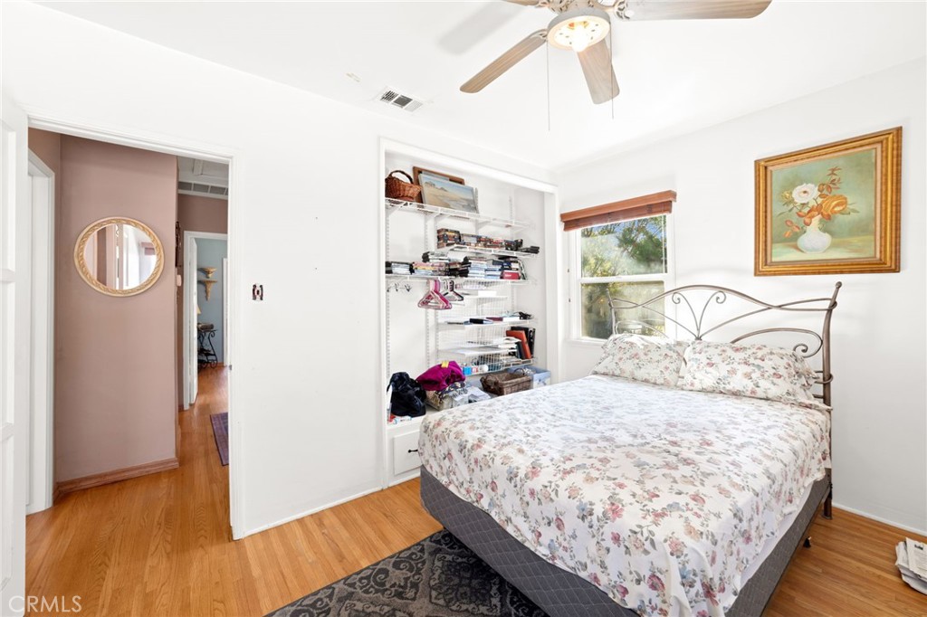 3924 Wayne Court Riverside, CA 92504 - Photo 23 of 31 a bedroom with a bed and wooden floor