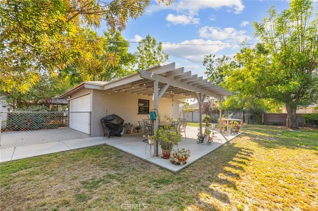 a view of a house with a yard patio and swimming pool