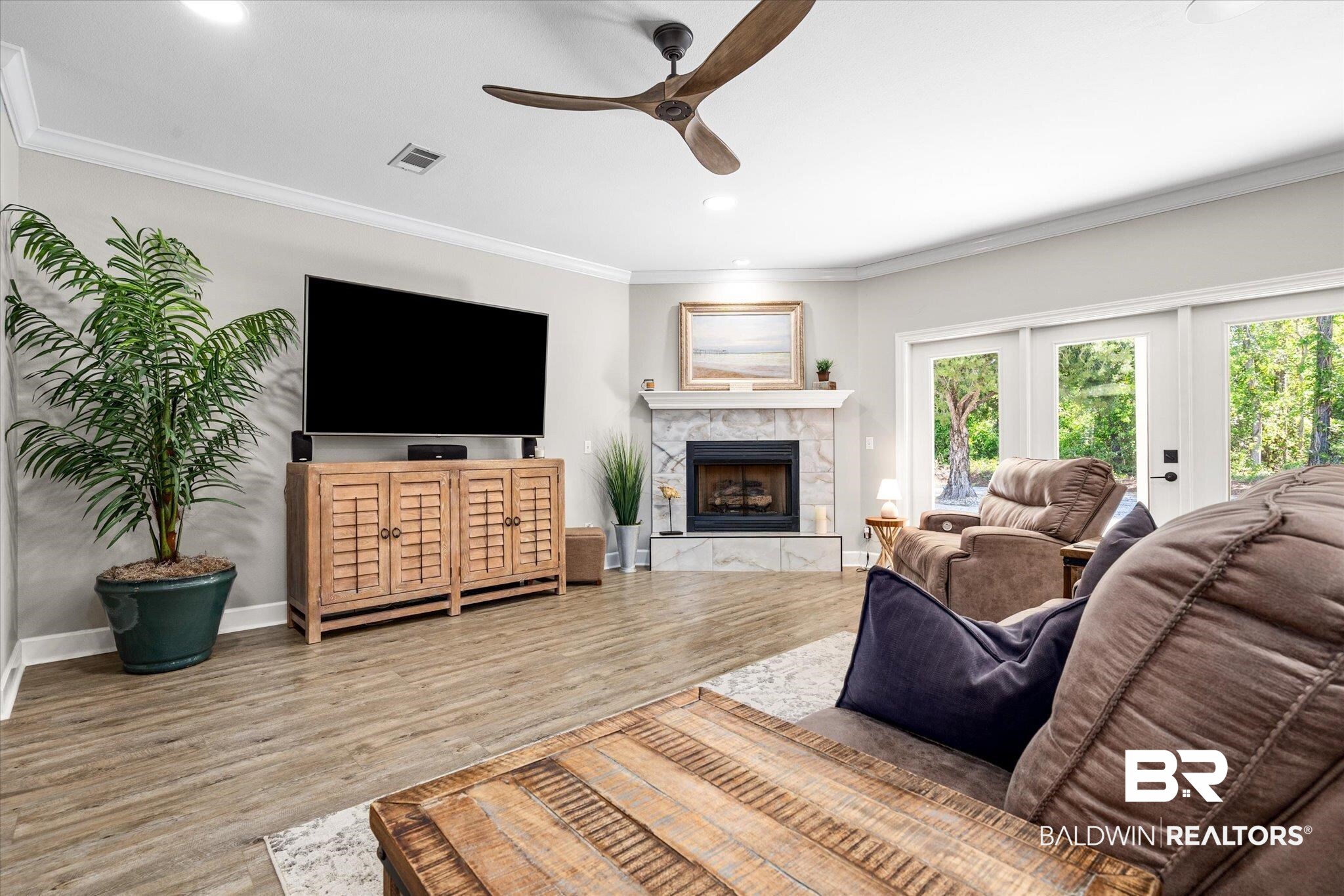 4947 Look Rook Road Orange Beach, AL 36561 - Photo 3 of 24 Living room with crown molding, visible vents, ceiling fan, and a wealth of natural light