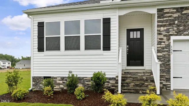 a view of a house with potted plants