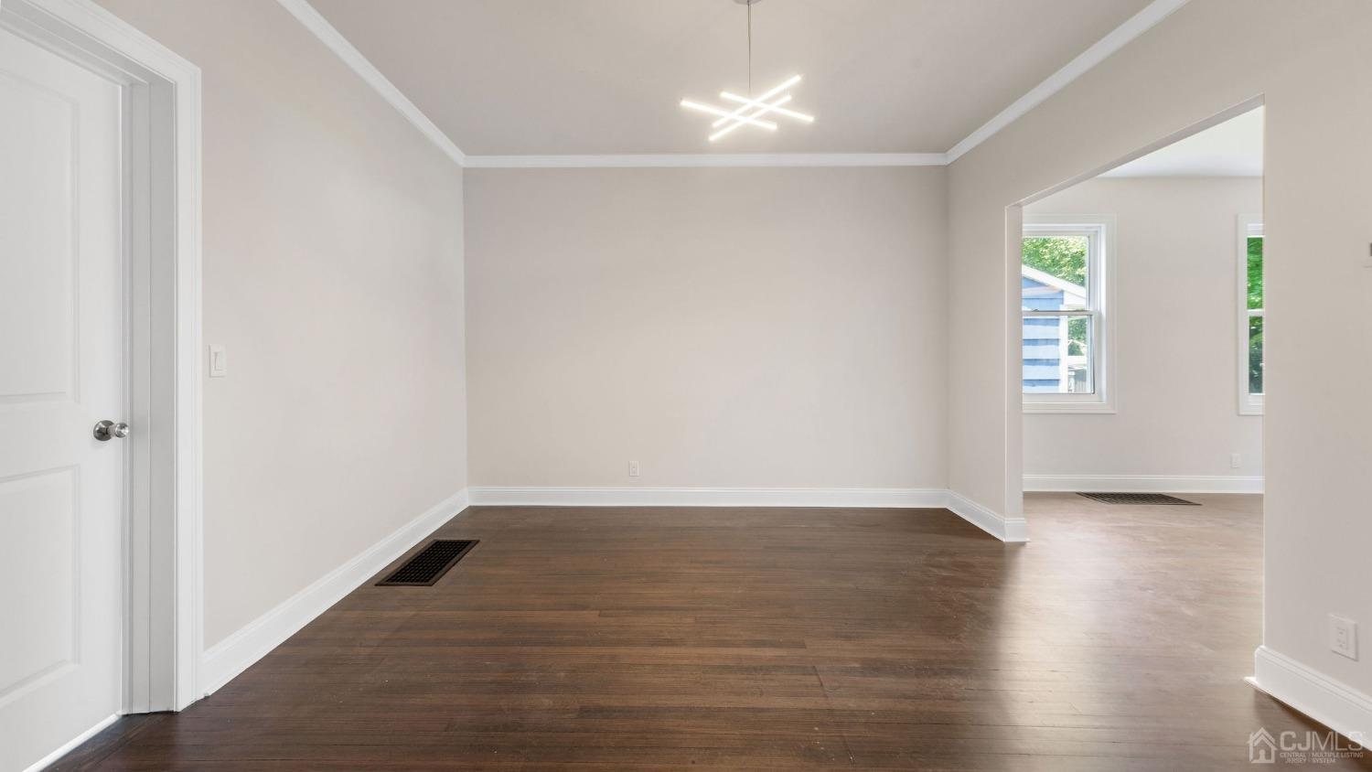718 Front Street Dunellen, NJ 08812 - Photo 13 of 28 an empty room with wooden floor and windows