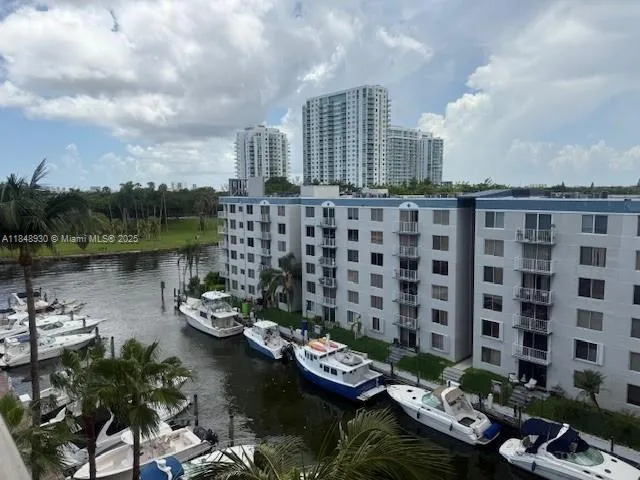 a view of a lake with tall buildings