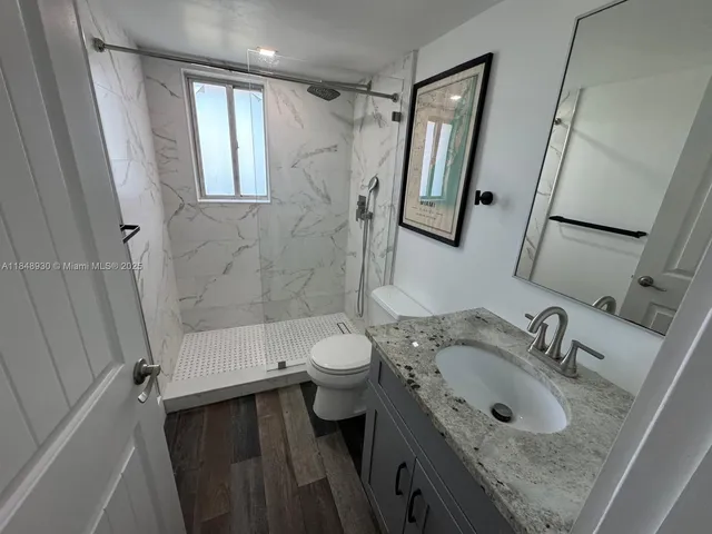 a bathroom with a sink toilet and shower