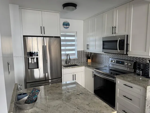 a kitchen with stainless steel appliances a refrigerator stove and microwave