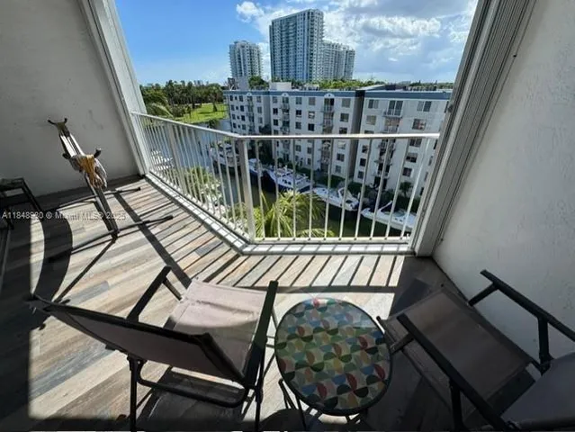 a view of balcony with wooden floor outdoor seating and outdoor seating
