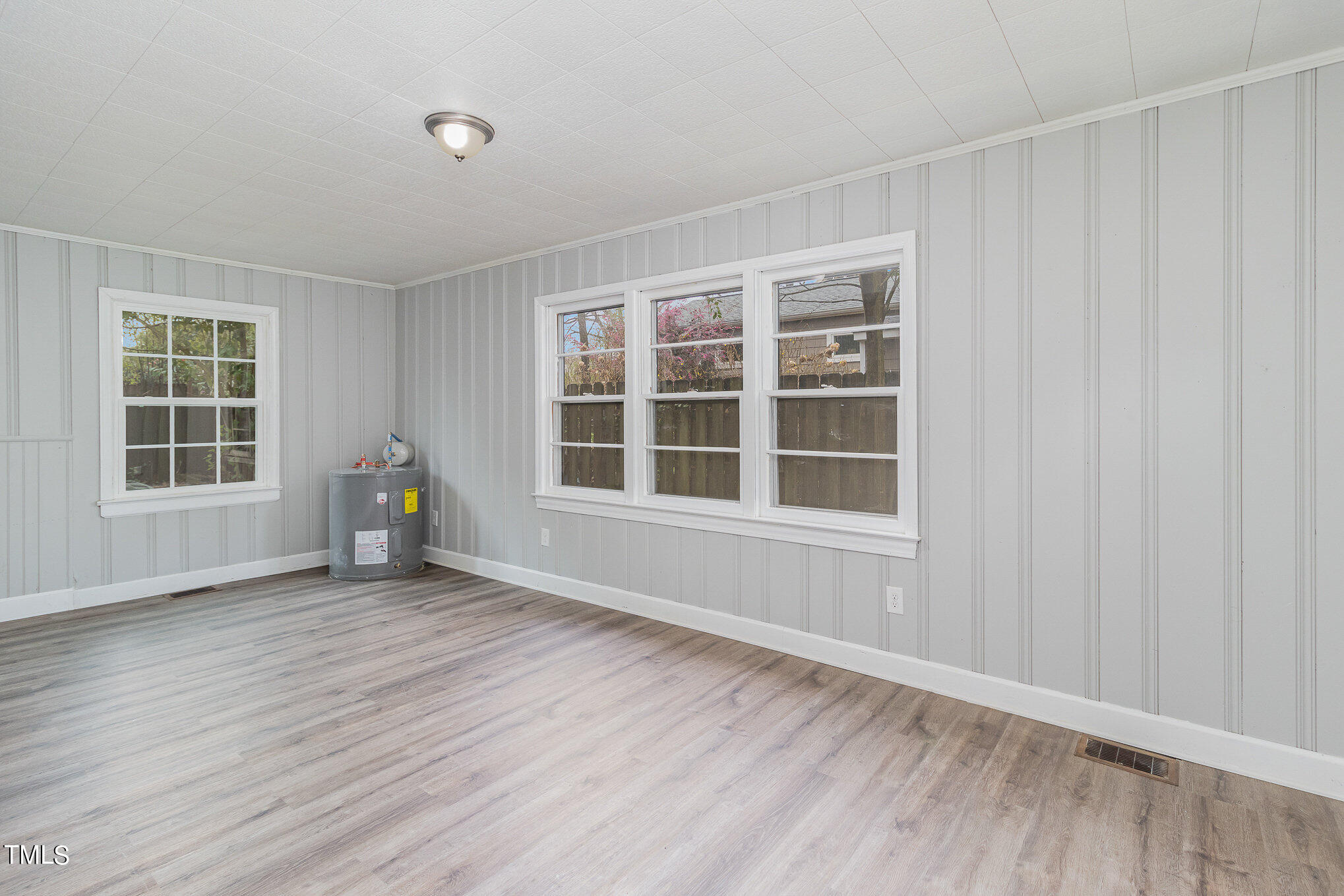 2813 Fowler Avenue Raleigh, NC 27607 - Photo 11 of 30 a view of an empty room with a window and wooden floor