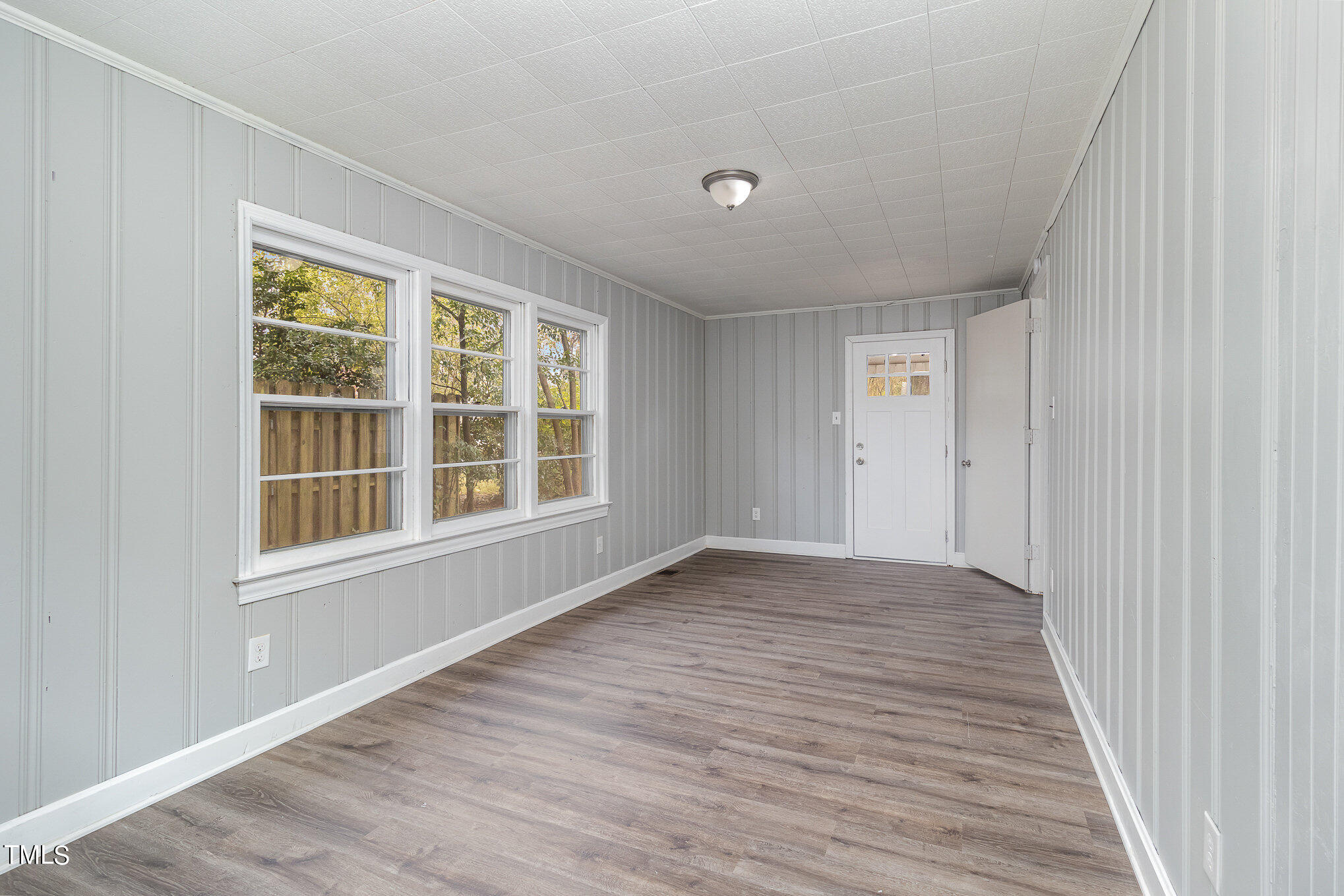 2813 Fowler Avenue Raleigh, NC 27607 - Photo 12 of 30 a view of an empty room with wooden floor and a window