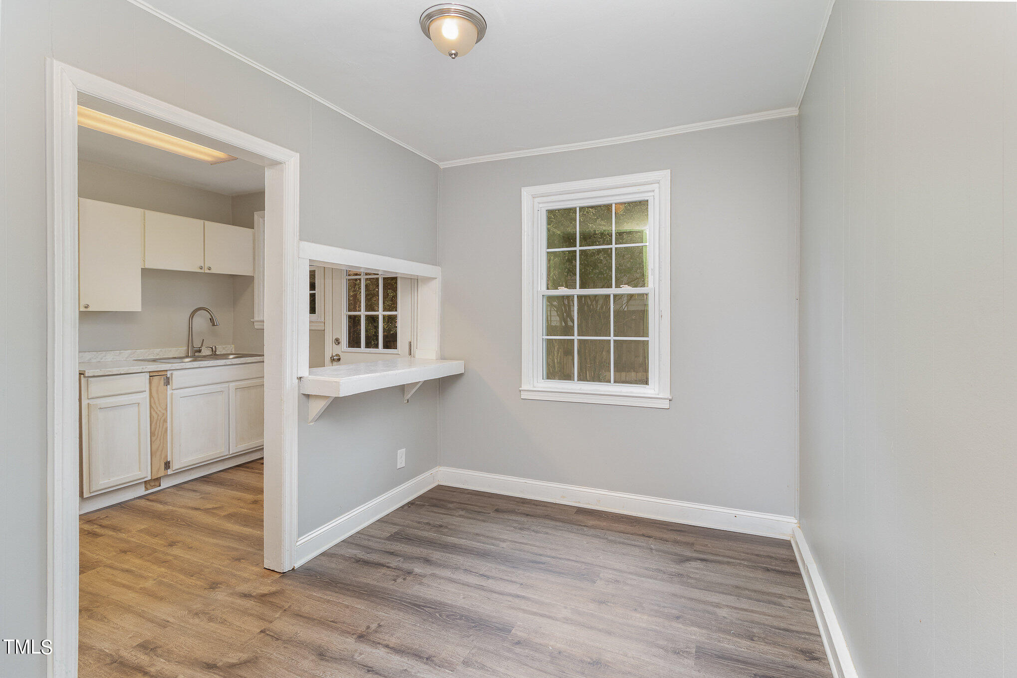 2813 Fowler Avenue Raleigh, NC 27607 - Photo 14 of 30 a view of an empty room with a kitchen and a window