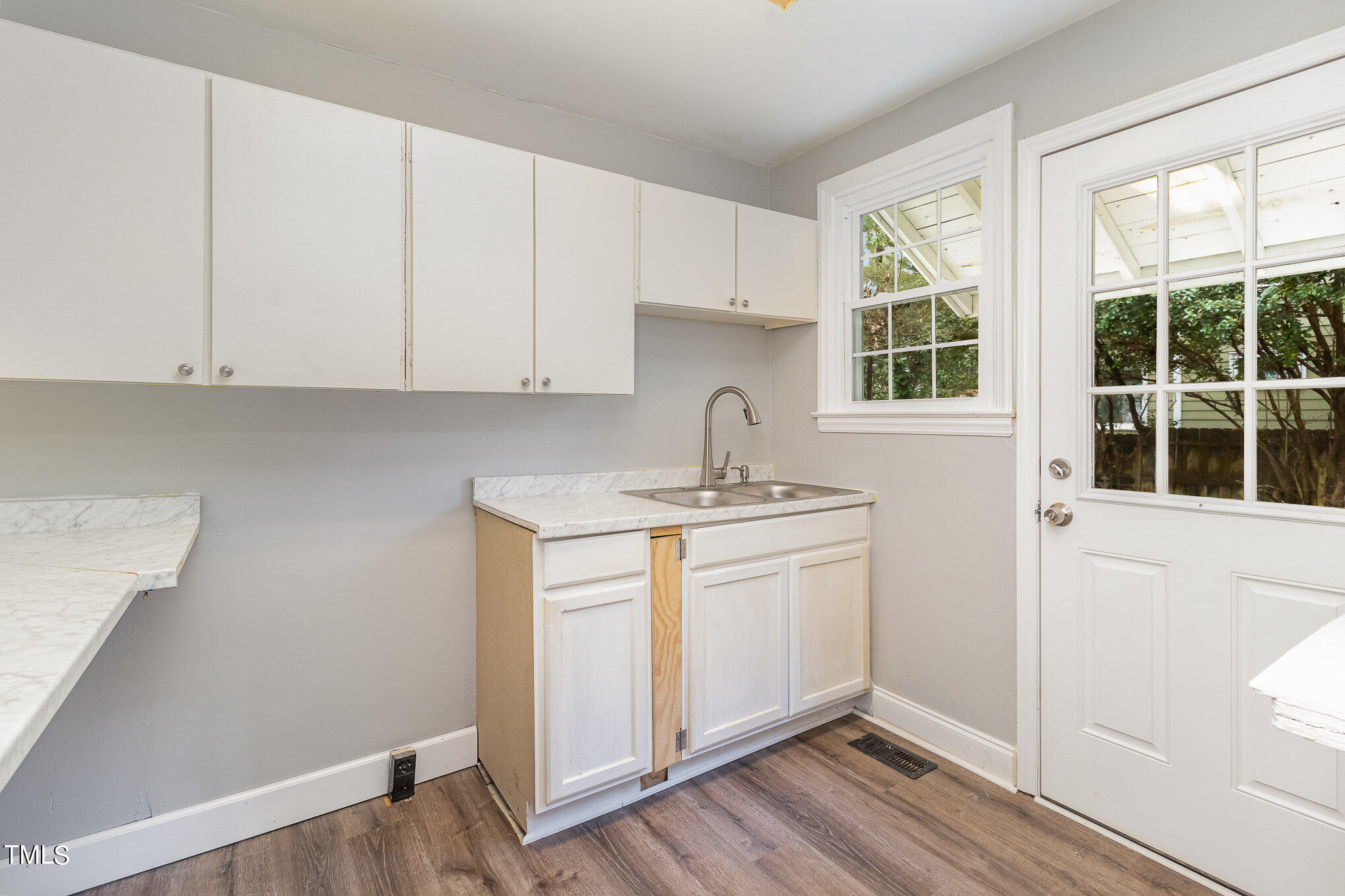 2813 Fowler Avenue Raleigh, NC 27607 - Photo 16 of 30 a kitchen with granite countertop white cabinets and sink