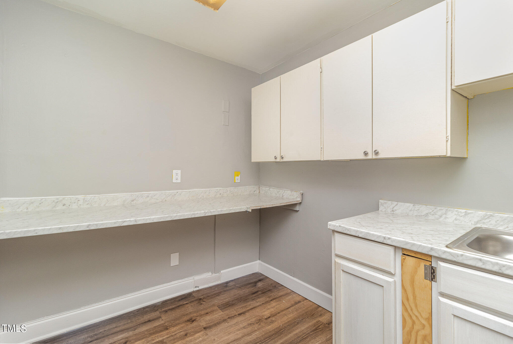 2813 Fowler Avenue Raleigh, NC 27607 - Photo 18 of 30 a kitchen with white cabinets and a sink