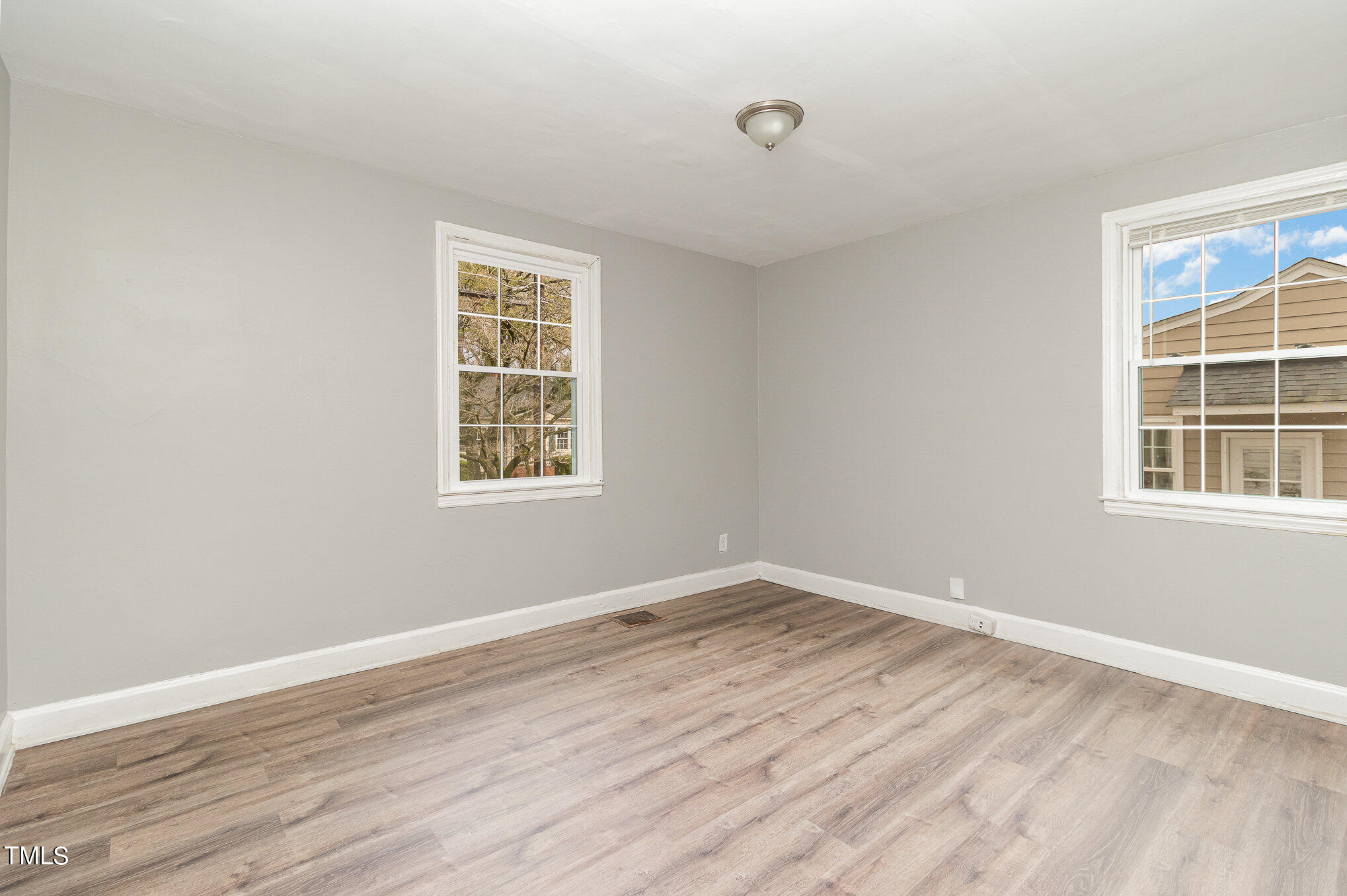 2813 Fowler Avenue Raleigh, NC 27607 - Photo 22 of 30 a view of an empty room with wooden floor and a window