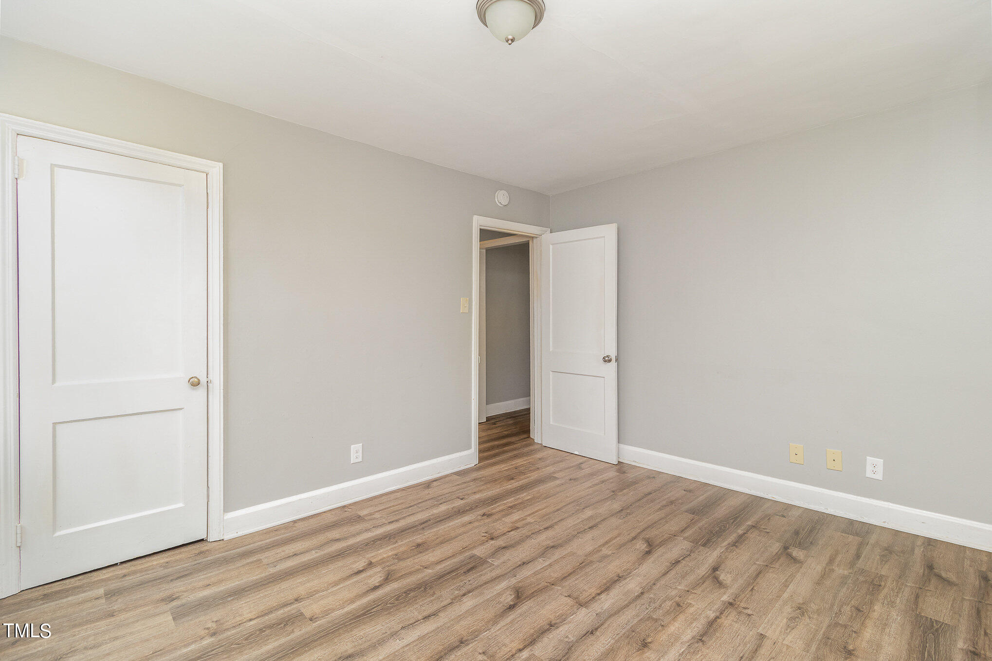 2813 Fowler Avenue Raleigh, NC 27607 - Photo 23 of 30 a view of an empty room with wooden floor and closet
