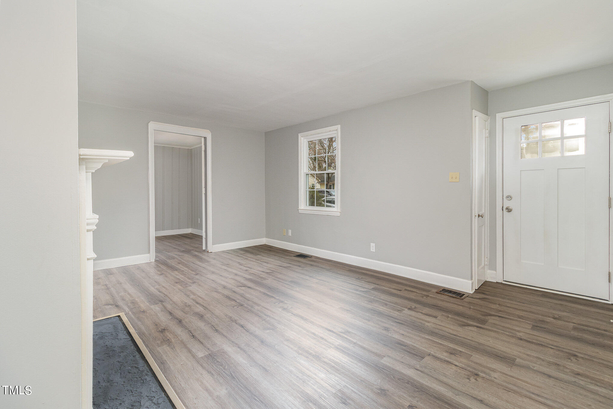 2813 Fowler Avenue Raleigh, NC 27607 - Photo 9 of 30 an empty room with wooden floor and windows