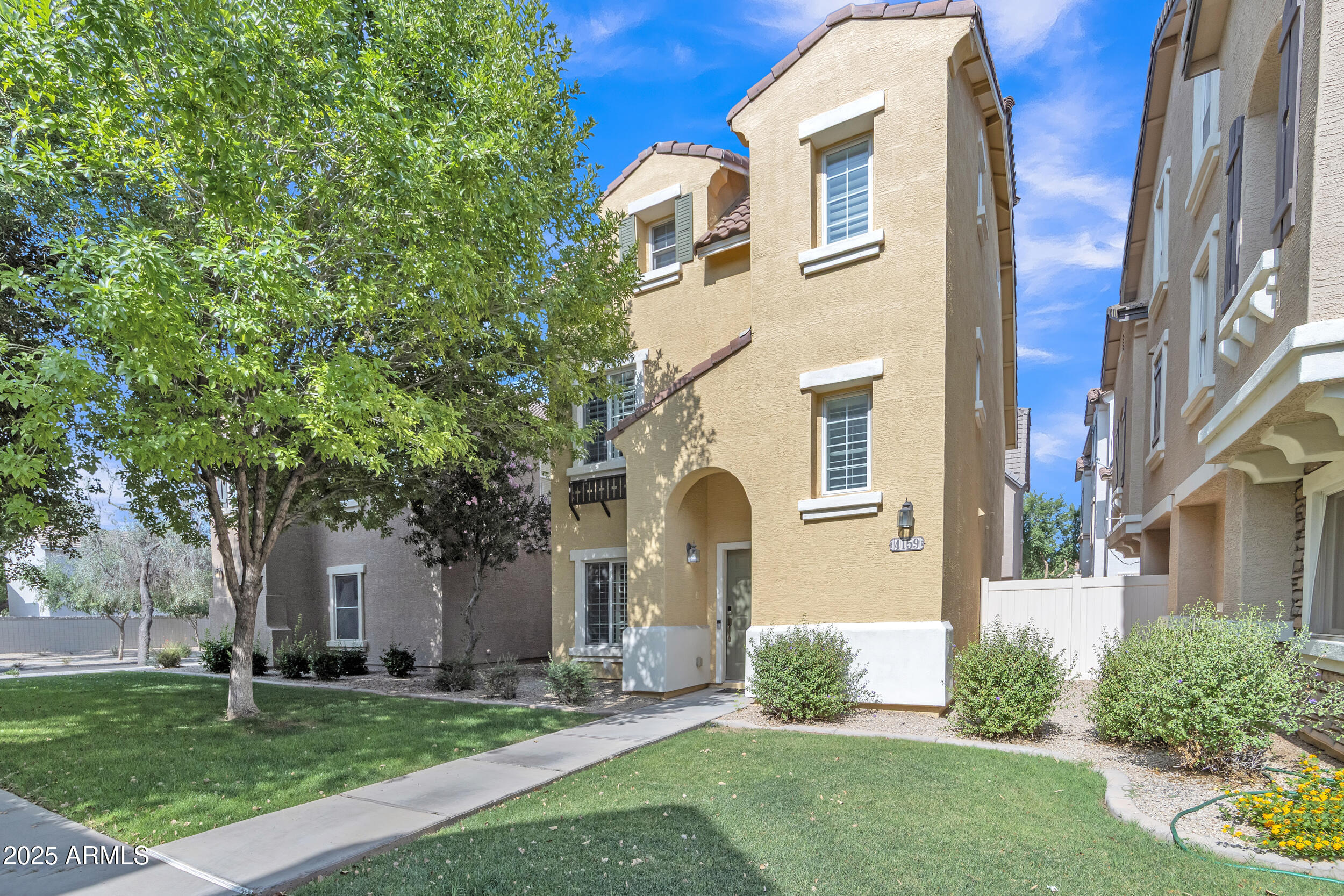 a front view of a house with a garden