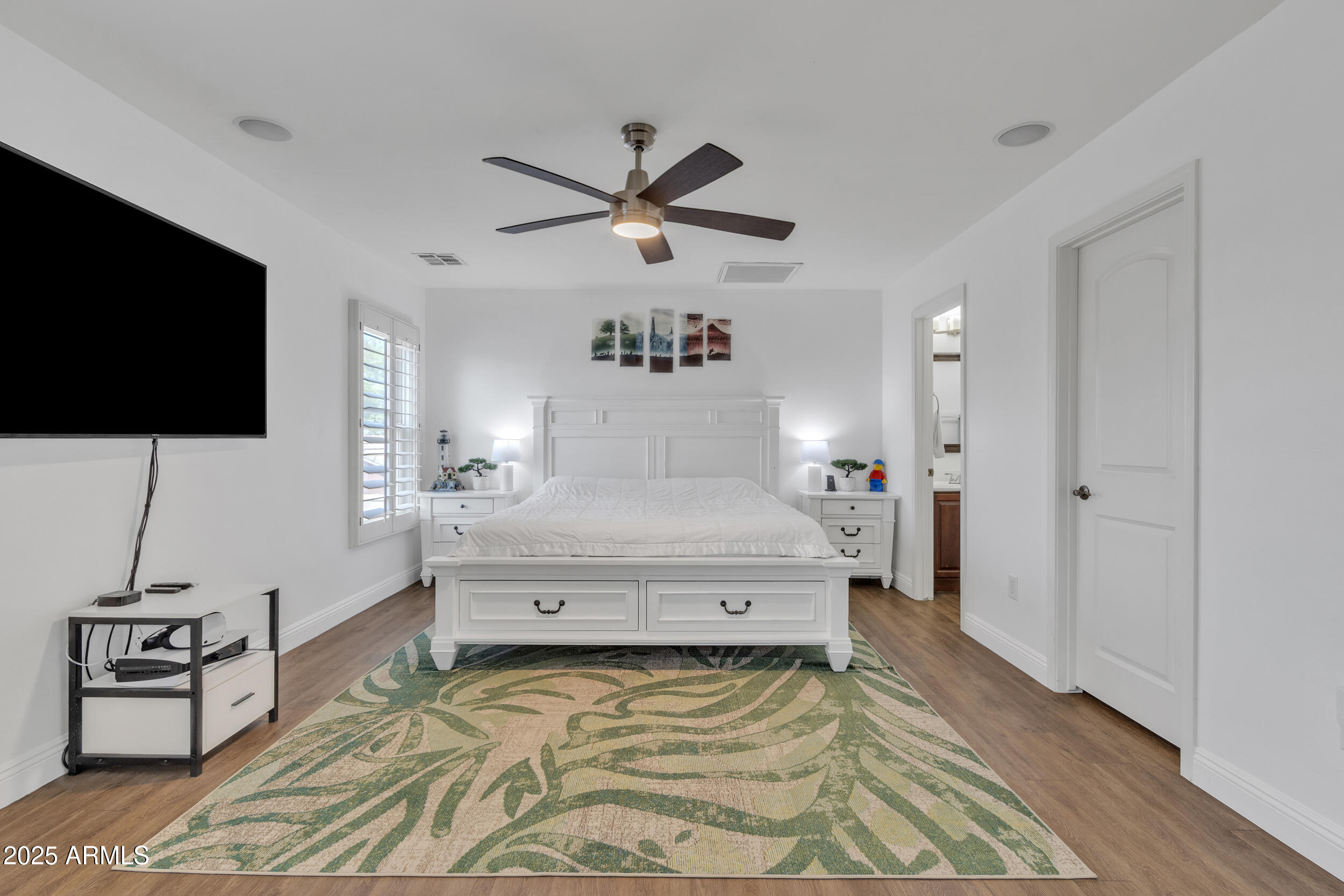 4159 East Jasper Drive Gilbert, AZ 85296 - Photo 15 of 26 a spacious bedroom with a bed and a flat screen tv