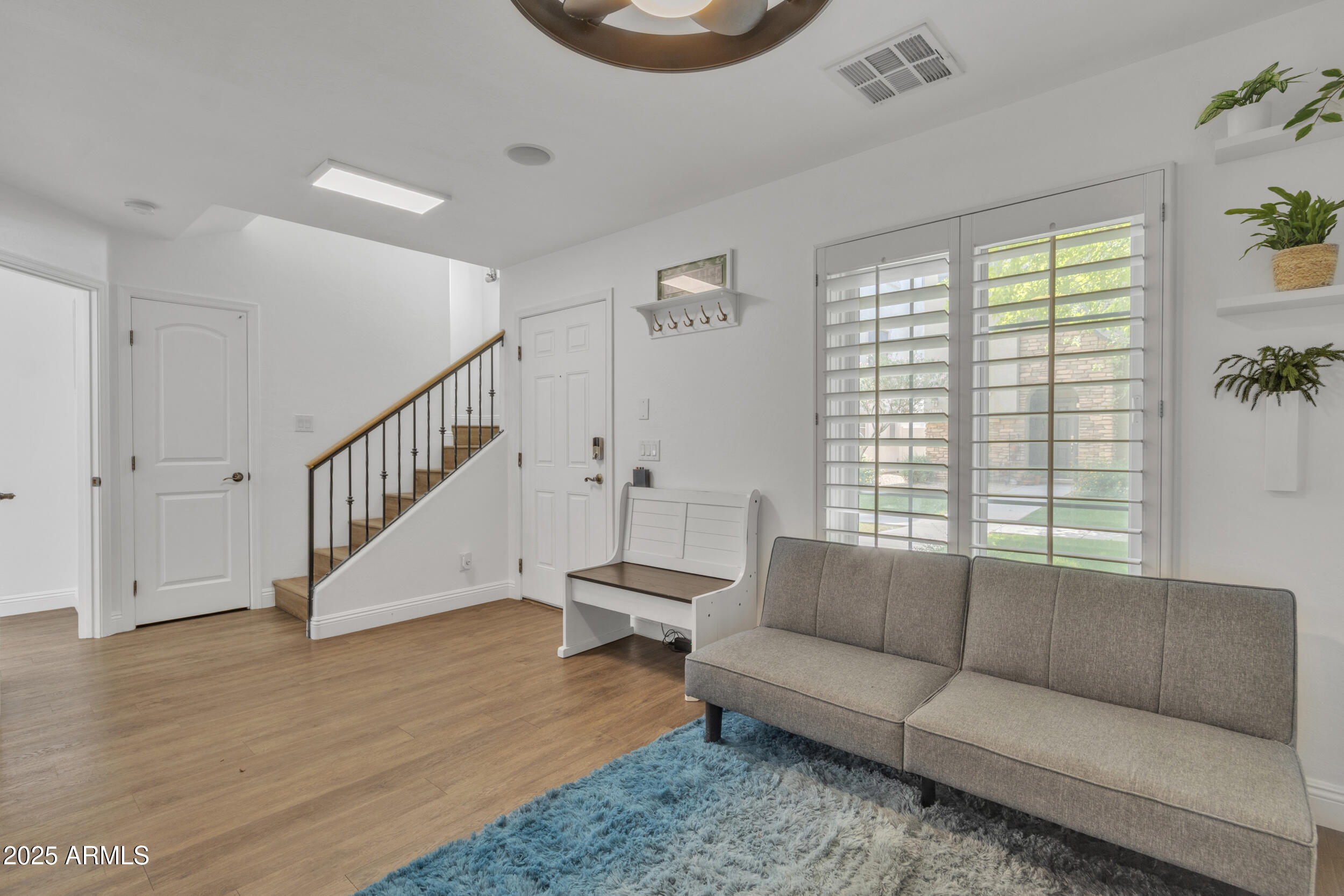 4159 East Jasper Drive Gilbert, AZ 85296 - Photo 20 of 26 a living room with furniture and a wooden floor