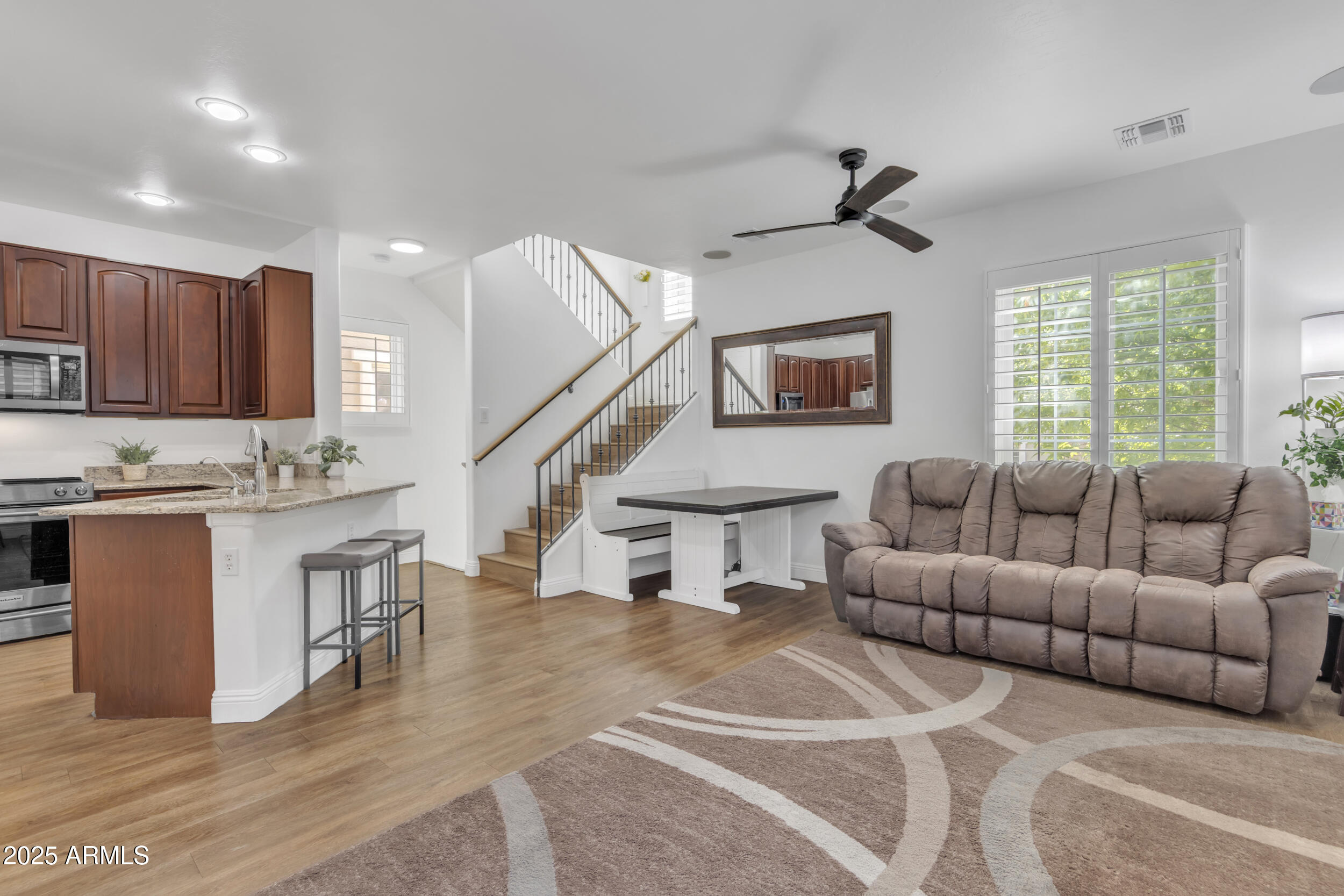 4159 East Jasper Drive Gilbert, AZ 85296 - Photo 7 of 26 a living room with furniture a wooden floor and a ceiling fan