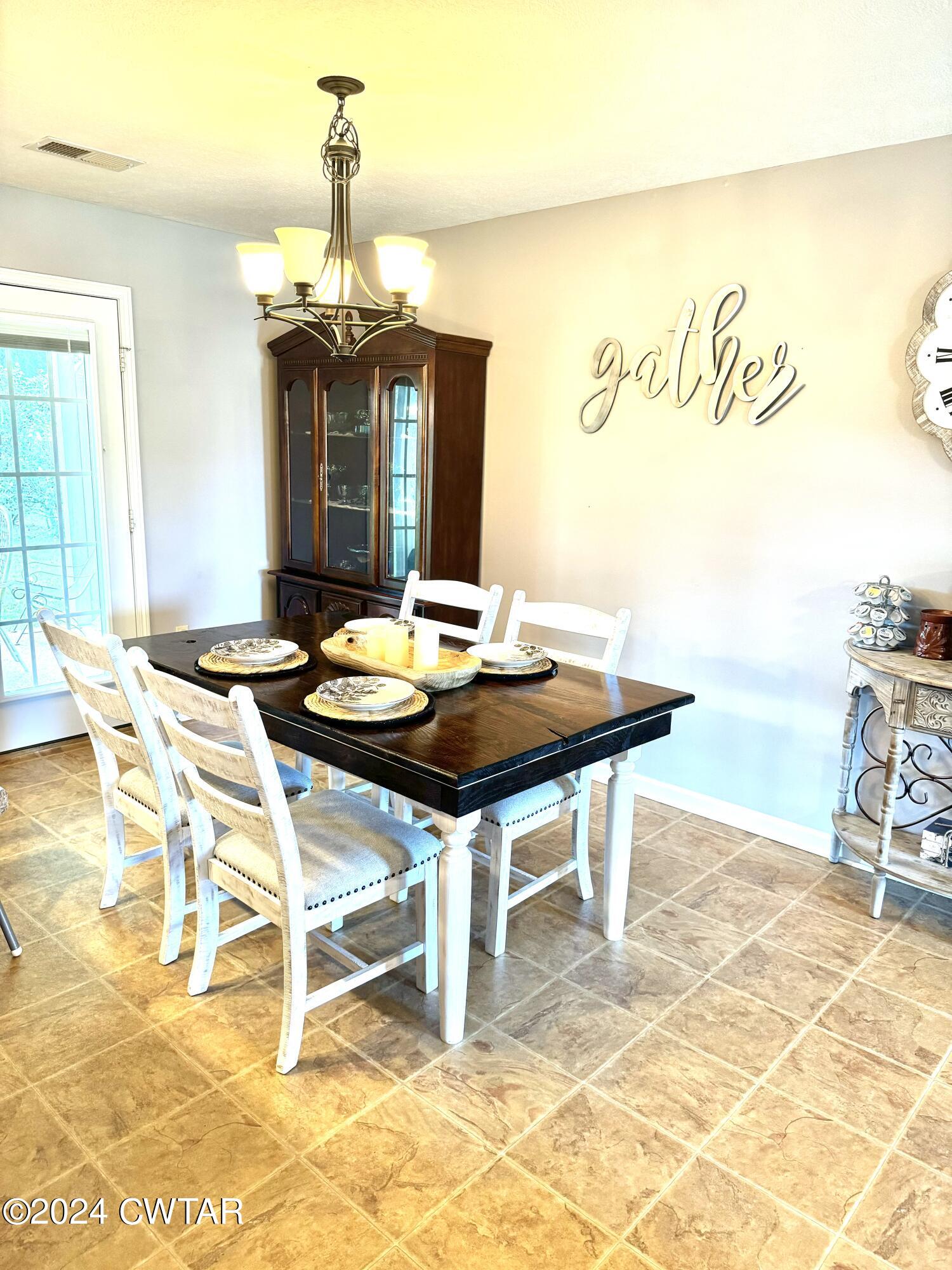 870 Simmons Road Henderson, TN 38340 - Photo 6 of 14 a view of a dining room with furniture and wooden floor