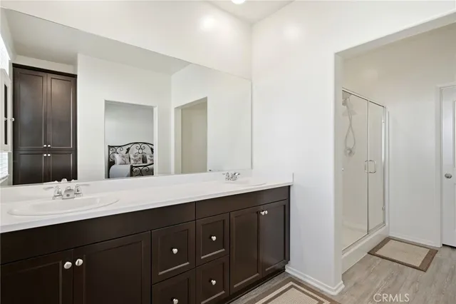 a bathroom with a double vanity sink and mirror