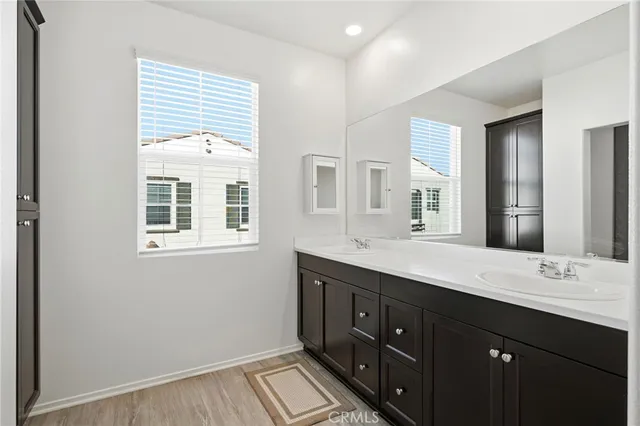 a bathroom with a double vanity sink and a mirror