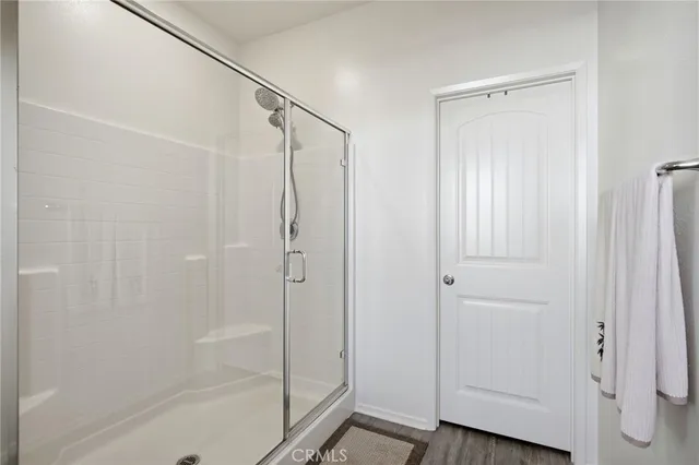 a bathroom with a glass shower door