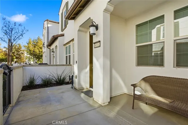 a view of a house with a chairs and table in a patio