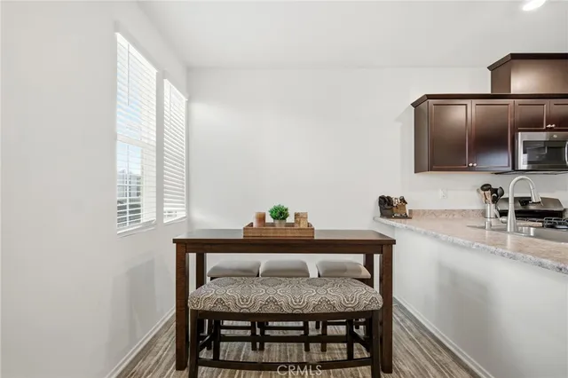 a dining room with furniture and window