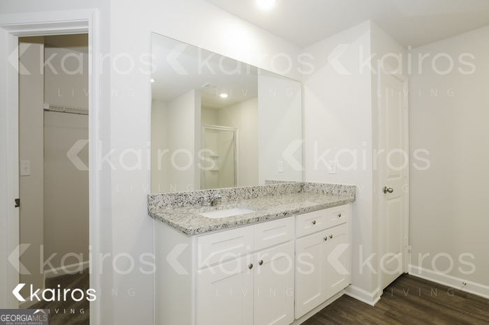 7008 Pinehurst Way North Macon, GA 31216 - Photo 12 of 16 a bathroom with a granite countertop sink and a mirror