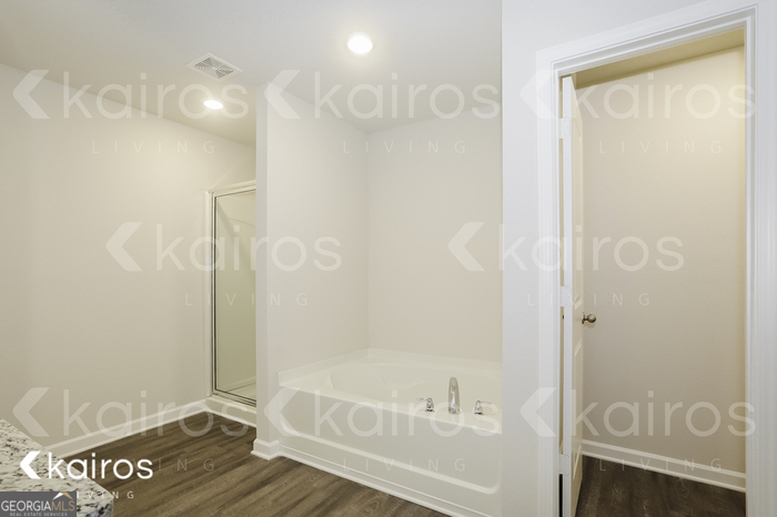 7008 Pinehurst Way North Macon, GA 31216 - Photo 13 of 16 a bathroom with a tub and shower