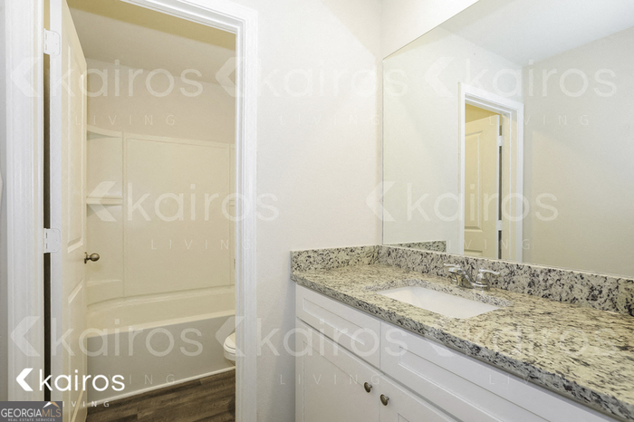 7008 Pinehurst Way North Macon, GA 31216 - Photo 4 of 16 a bathroom with a granite countertop sink and a mirror