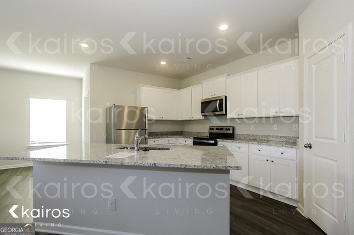 7008 Pinehurst Way North Macon, GA 31216 - Photo 5 of 16 a kitchen with granite countertop stainless steel appliances a sink a stove a microwave a counter top space and cabinets