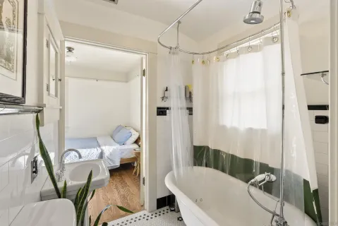 a bathroom with a tub toilet and shower