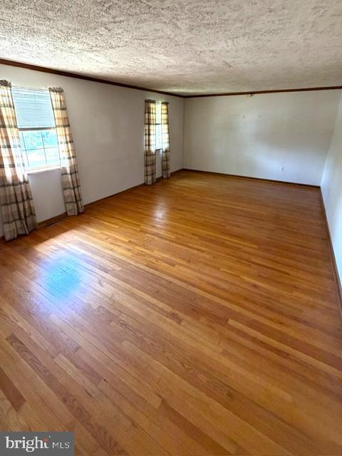 108 Kingbrook Road Linthicum Heights, MD 21090 - Photo 7 of 15 an empty room with wooden floor and windows
