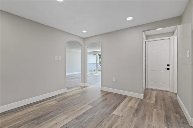 a view of empty room with wooden floor