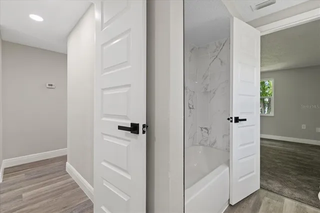 a bathroom with a bathtub and a shower