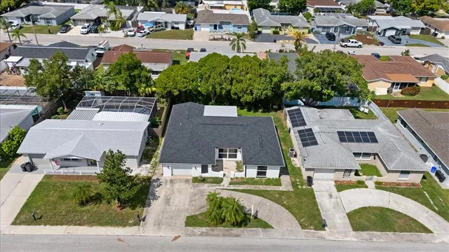 an aerial view of residential houses with outdoor space and street view