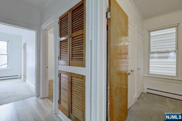 58 Westervelt Avenue, Unit 1 Hawthorne, NJ 07506 - Photo 12 of 17 a view of a hallway with wooden floor and windows