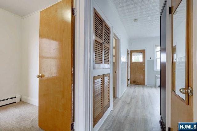 58 Westervelt Avenue, Unit 1 Hawthorne, NJ 07506 - Photo 5 of 17 a view of a hallway with wooden floor and closet area