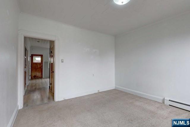 58 Westervelt Avenue, Unit 1 Hawthorne, NJ 07506 - Photo 6 of 17 wooden floor and cabinet in an empty room