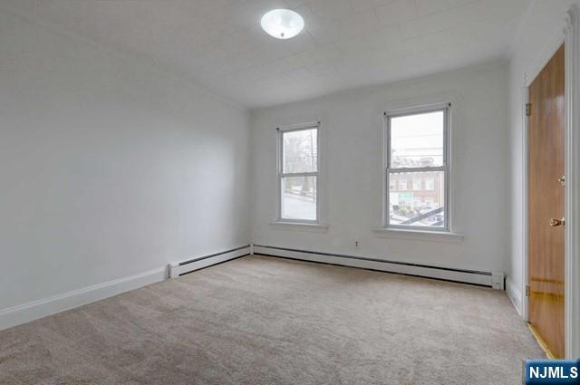 58 Westervelt Avenue, Unit 1 Hawthorne, NJ 07506 - Photo 7 of 17 an empty room with windows
