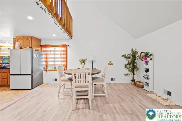 a dining room with furniture and wooden floor
