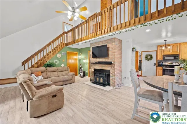 a living room with furniture a fireplace and a flat screen tv