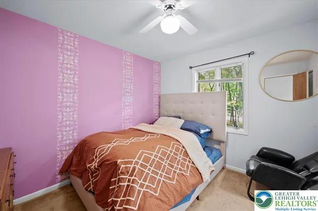 a bedroom with a bed and a chair