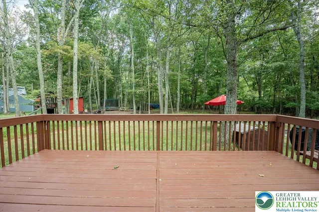 a view of balcony with wooden floor and fence